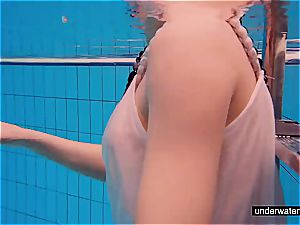teenager chick Avenna is swimming in the pool