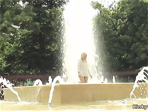 blonde made to bathtub in public fountain