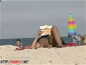 sizzling honies filmed lying on a naturist beach